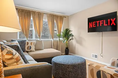 a living room with a netflix sign on the wall at Uptown Escape in Mount Vernon