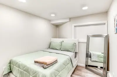 a small bedroom with a bed and a mirror at 14 Mi to Central Park Chic Mt Vernon Retreat in Vernon Park