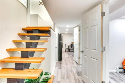 a stairwell in a home with wooden shelves at 14 Mi to Central Park Chic Mt Vernon Retreat in Vernon Park