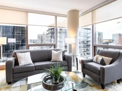 a living room with two couches and a glass table at Luxury Apt with Gym Downtown in Stamford