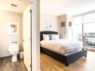 a bedroom with a bed and a toilet at Luxury Apt with Gym Downtown in Stamford