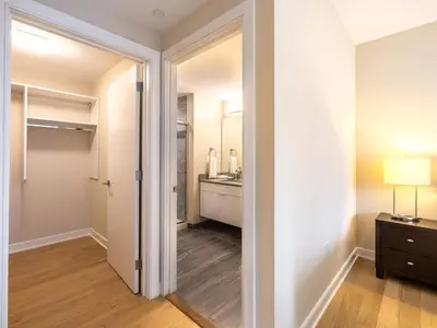 a hallway with a door leading to a bathroom at Luxury Apt with Gym Downtown in Stamford