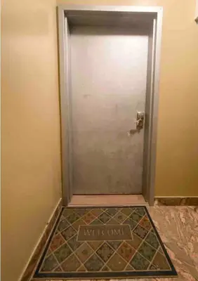a door with a welcome mat in front of it at Rayhaan Palace in Long Island City