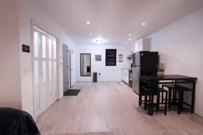a kitchen with a refrigerator and a table in a room at Bocca Studio in Long Island City