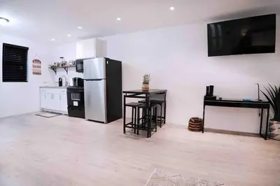 a kitchen with a refrigerator and a table in it at Bocca Studio in Long Island City