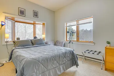 a bedroom with a large bed and two windows at Walk to Mount Snow Resort Unit with Pool and Hot Tubs in Dover