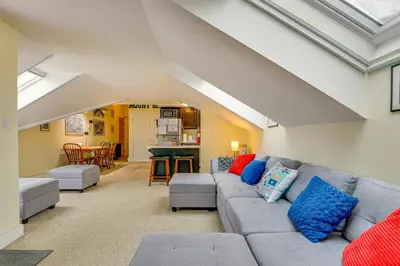 a living room with a couch and a table at Walk to Mount Snow Resort Unit with Pool and Hot Tubs in Dover