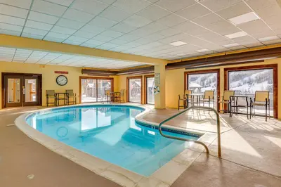 a large swimming pool in a hotel room at Walk to Mount Snow Resort Unit with Pool and Hot Tubs in Dover
