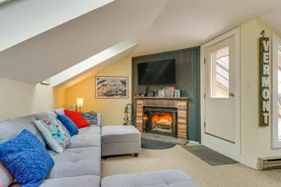a living room with a couch and a fireplace at Walk to Mount Snow Resort Unit with Pool and Hot Tubs in Dover