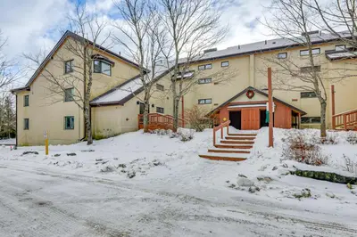 a large building with snow in front of it at Walk to Mount Snow Resort Unit with Pool and Hot Tubs in Dover