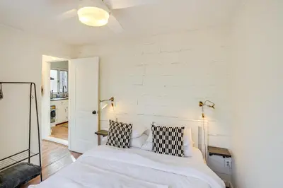 a bedroom with white walls and a bed with black and white pillows at Mtn Views and On-Site Hiking Trails Catskills Cabin in Round Top