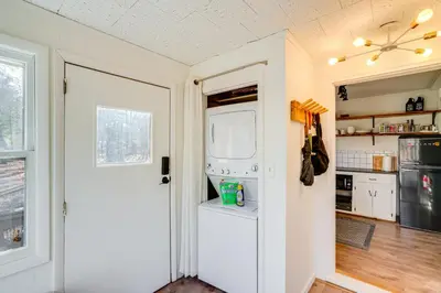 a kitchen with a white refrigerator and a door at Mtn Views and On-Site Hiking Trails Catskills Cabin in Round Top