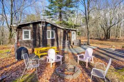 a tiny house with chairs and a fire pit at Mtn Views and On-Site Hiking Trails Catskills Cabin in Round Top