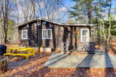 a small house with a picnic table in front of it at Mtn Views and On-Site Hiking Trails Catskills Cabin in Round Top