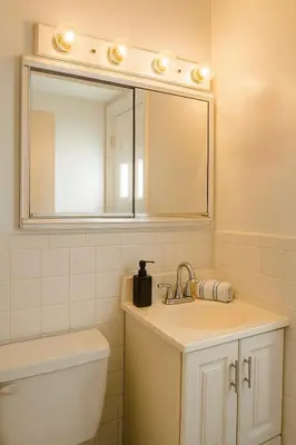 a bathroom with a sink and a mirror at 10 Min to NYC Quiet 1BR Flash Deal June 22 to 25 in Weehawken