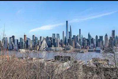 a view of a large city with a skyline at 10 Min to NYC Quiet 1BR Flash Deal June 22 to 25 in Weehawken