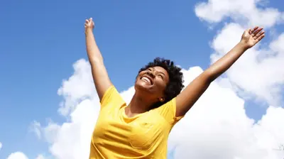 a woman in a yellow shirt with her hands in the air at Lovely apartment in New York