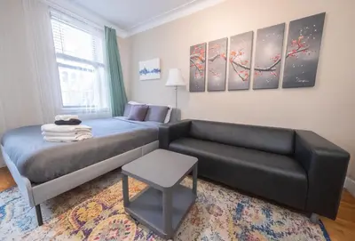 a living room with a bed and a couch at Bright Studio in Central NYC in New York