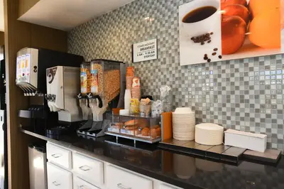 a kitchen counter with a coffee maker and aasteryasteryasteryasteryasteryasteryastery at Capital Inn and Suites in Rensselaer