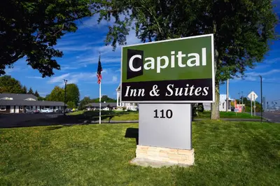 a sign for a car rental firm and suites at Capital Inn and Suites in Rensselaer