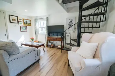 a living room with two couches and a piano at Hadley Hideaway Cottage in Hadley