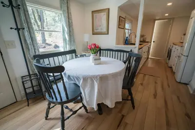 a dining room table with a white table cloth on it at Hadley Hideaway Cottage in Hadley