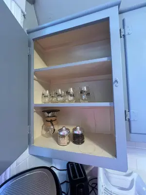a cupboard with a bunch of dishes in it at Waterfront NYC skyline views in Union City