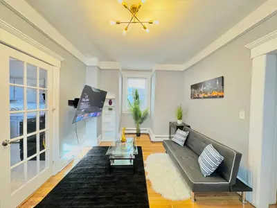 a living room with a couch and a table at Waterfront NYC skyline views in Union City