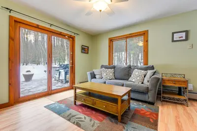 a living room with a couch and a table at 7 Mi to Mt Snow Resort Family Home with Fire Pit! in Dover