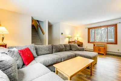 a living room with a couch and a table at 7 Mi to Mt Snow Resort Family Home with Fire Pit! in Dover