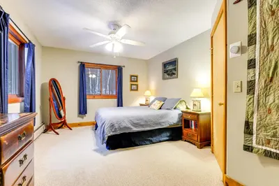a bedroom with a bed and a ceiling fan at 7 Mi to Mt Snow Resort Family Home with Fire Pit! in Dover