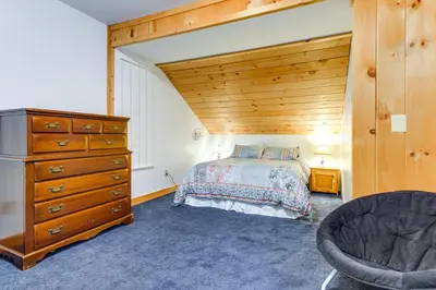 a bedroom with a bed and a dresser at 7 Mi to Mt Snow Resort Family Home with Fire Pit! in Dover