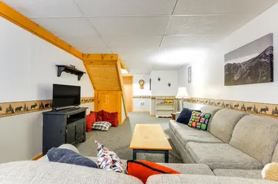 a living room with a couch and a tv at 7 Mi to Mt Snow Resort Family Home with Fire Pit! in Dover
