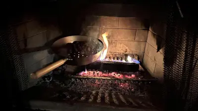 a pot is cooking meat in an oven at Black Bear Cabin in Windham
