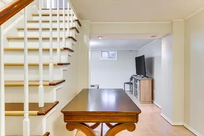 a dining room with a table and a tv at 3 Mi to Downtown Spacious White Plains Home in White Plains