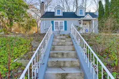 a stairway leading to a house with a blue house at 3 Mi to Downtown Spacious White Plains Home in White Plains