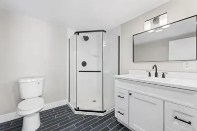 a white bathroom with a toilet and a sink at remember2giggle at gee mail to discuss and inquire in Avon