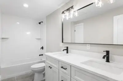 a bathroom with a sink and a toilet and a mirror at remember2giggle at gee mail to discuss and inquire in Avon