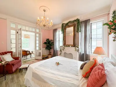 a bedroom with a large bed and a fireplace at NYC views Spacious 3 bedroom apartment in Union City
