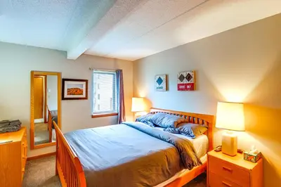 a bedroom with a large bed and two lamps at Snow Mountain Condo Hot Tub and Shuttle to Resort in West Dover
