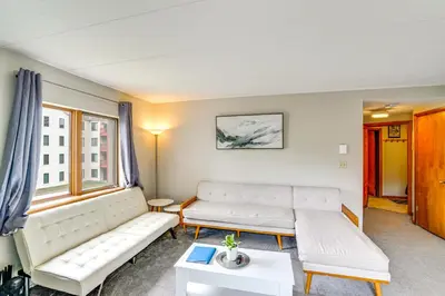 a living room with two white couches and a table at Snow Mountain Condo Hot Tub and Shuttle to Resort in West Dover