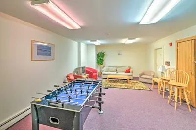 a room with a ping pong table in the middle at Snow Mountain Condo Hot Tub and Shuttle to Resort in West Dover