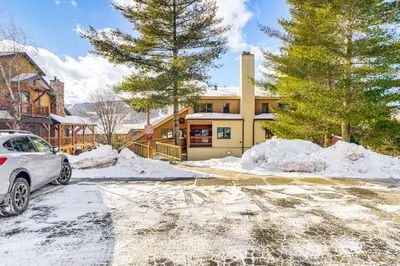 a car parked in front of a house in the snow at Snow Mountain Condo Hot Tub and Shuttle to Resort in West Dover