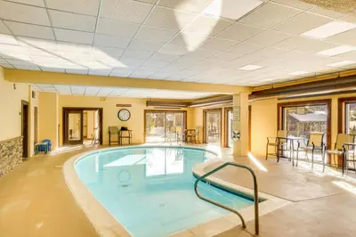 a large swimming pool in a building at Snow Mountain Condo Hot Tub and Shuttle to Resort in West Dover