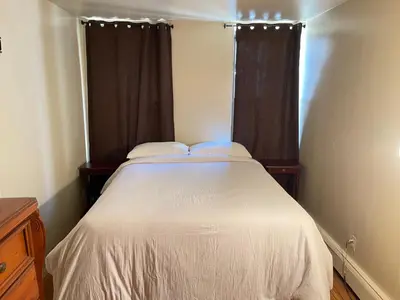 a bedroom with a white bed and a window at One Bedroom by Month Next to Bronx Zoo in West Farms