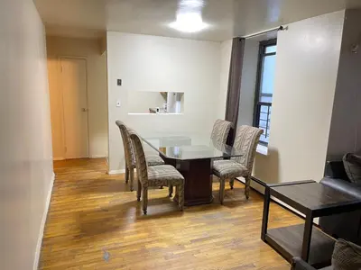 a dining room with a table and chairs at One Bedroom by Month Next to Bronx Zoo in West Farms