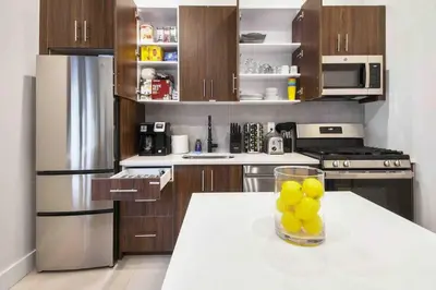a kitchen with a table with a bowl of lemons on it at Charming 1BR King Bed - Just 20 Minutes from NYC! in Newark
