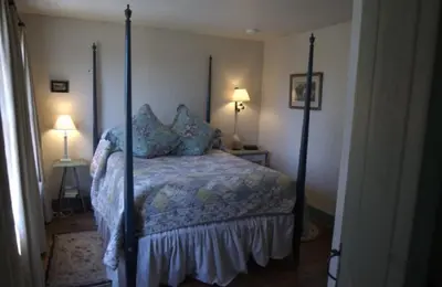 a bedroom with a bed with four posts at The Old Inn On The Green in New Marlborough