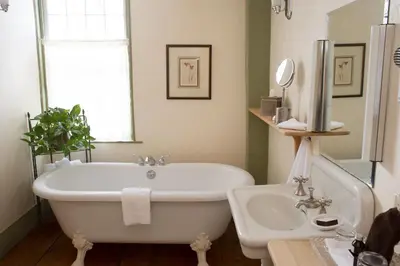 a bathroom with a tub and a sink at The Old Inn On The Green in New Marlborough