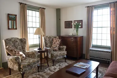 a living room with two chairs and a table at The Old Inn On The Green in New Marlborough